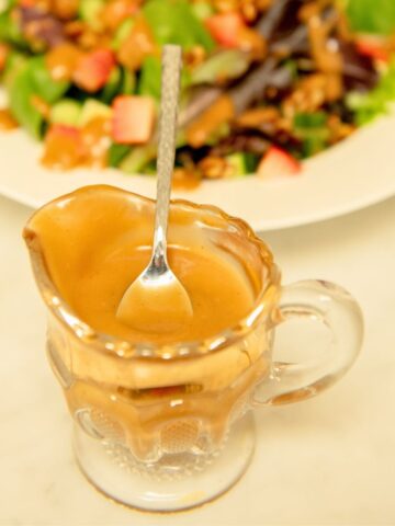 Spoon in a boat of balsamic dressing.