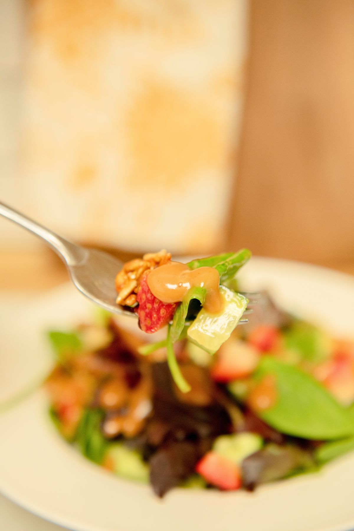 Forkful of salad with homemade balsamic dressing.