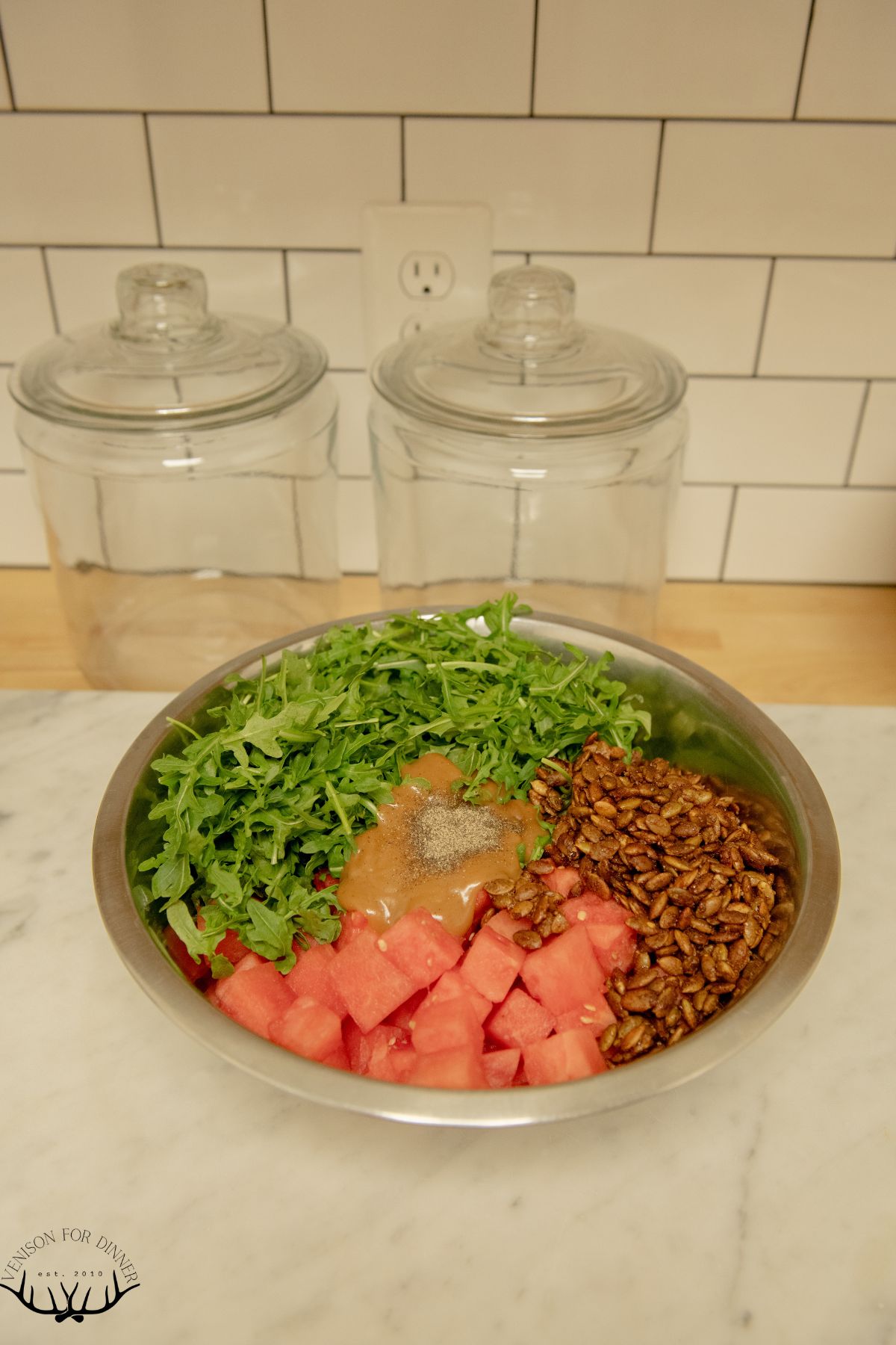 Watermelon salad ingredients in a bowl.