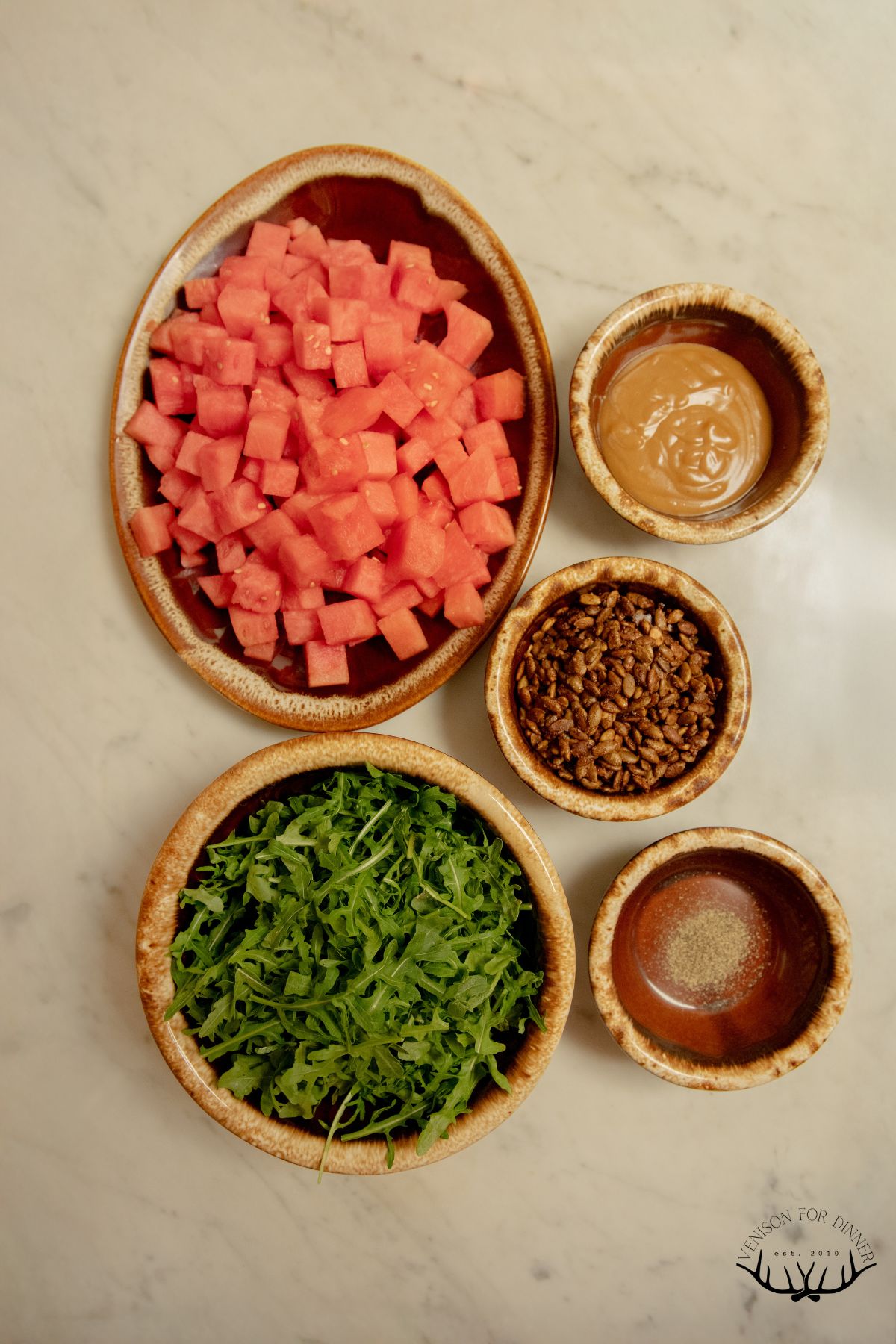 Ingredients to make watermelon arugula salad.