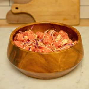 Diced watermelon with red onion in a salad bowl.