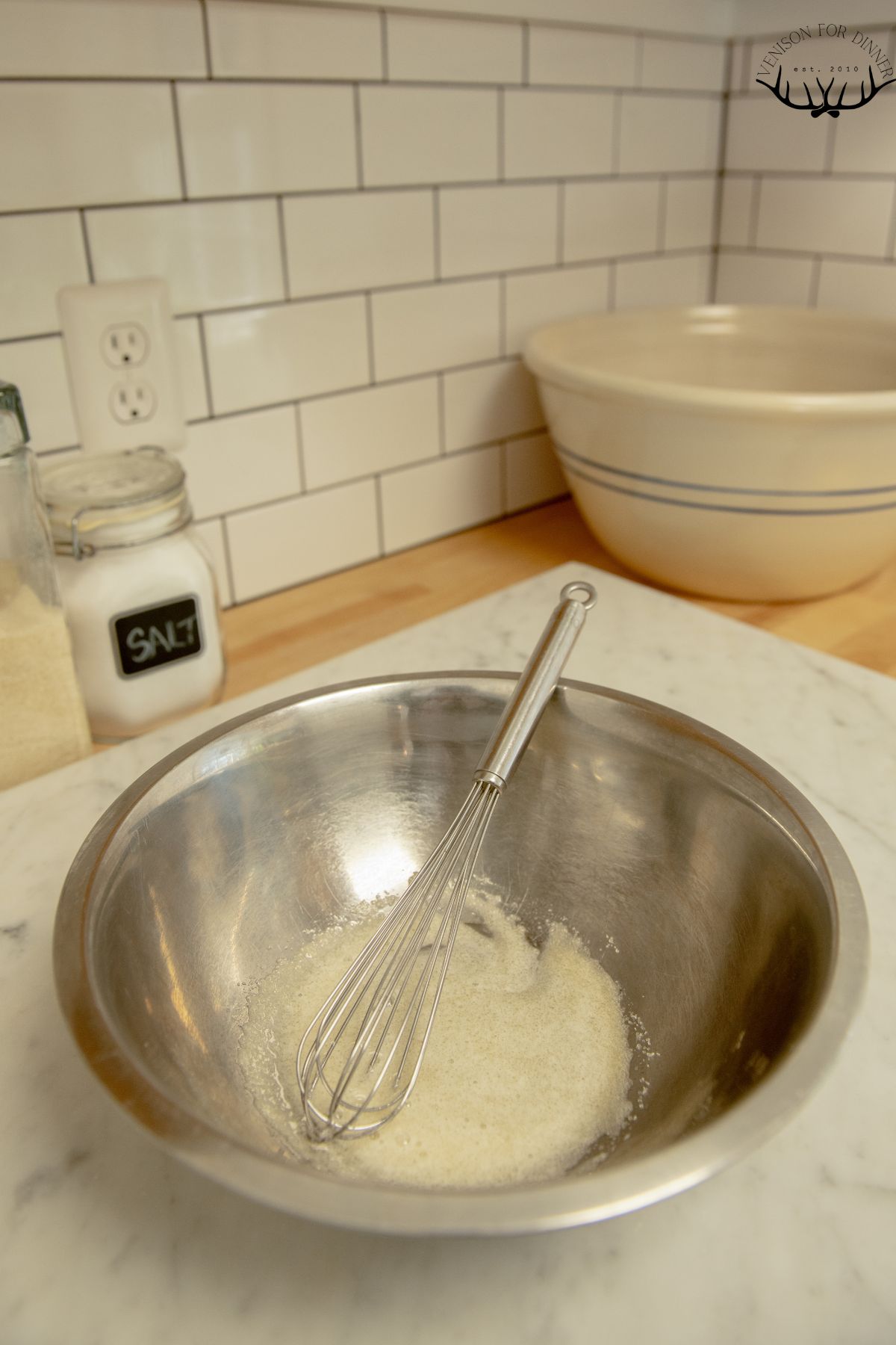 Egg whites and sugar whisked in a bowl.