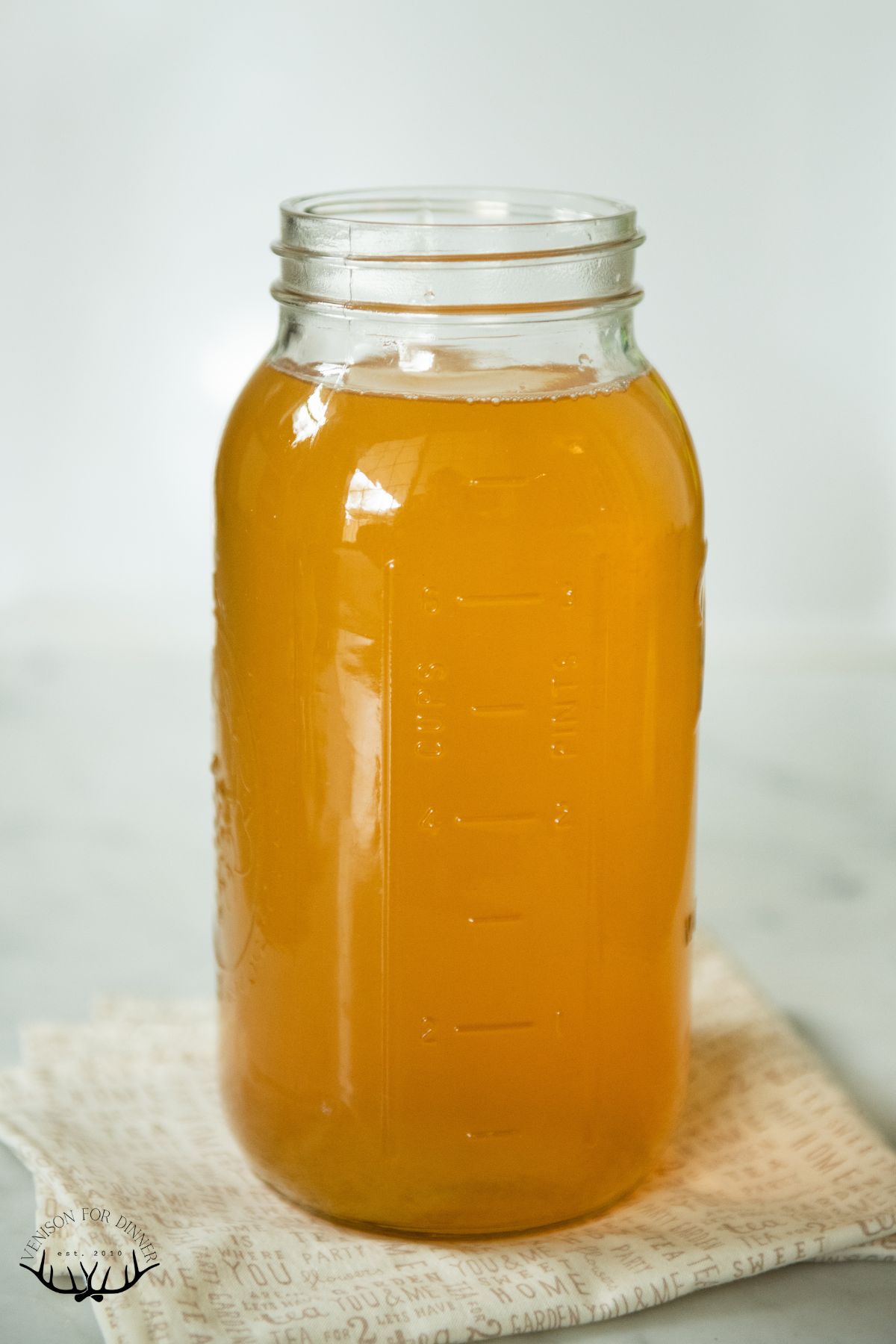 Jar of freshly brewed black tea with honey.