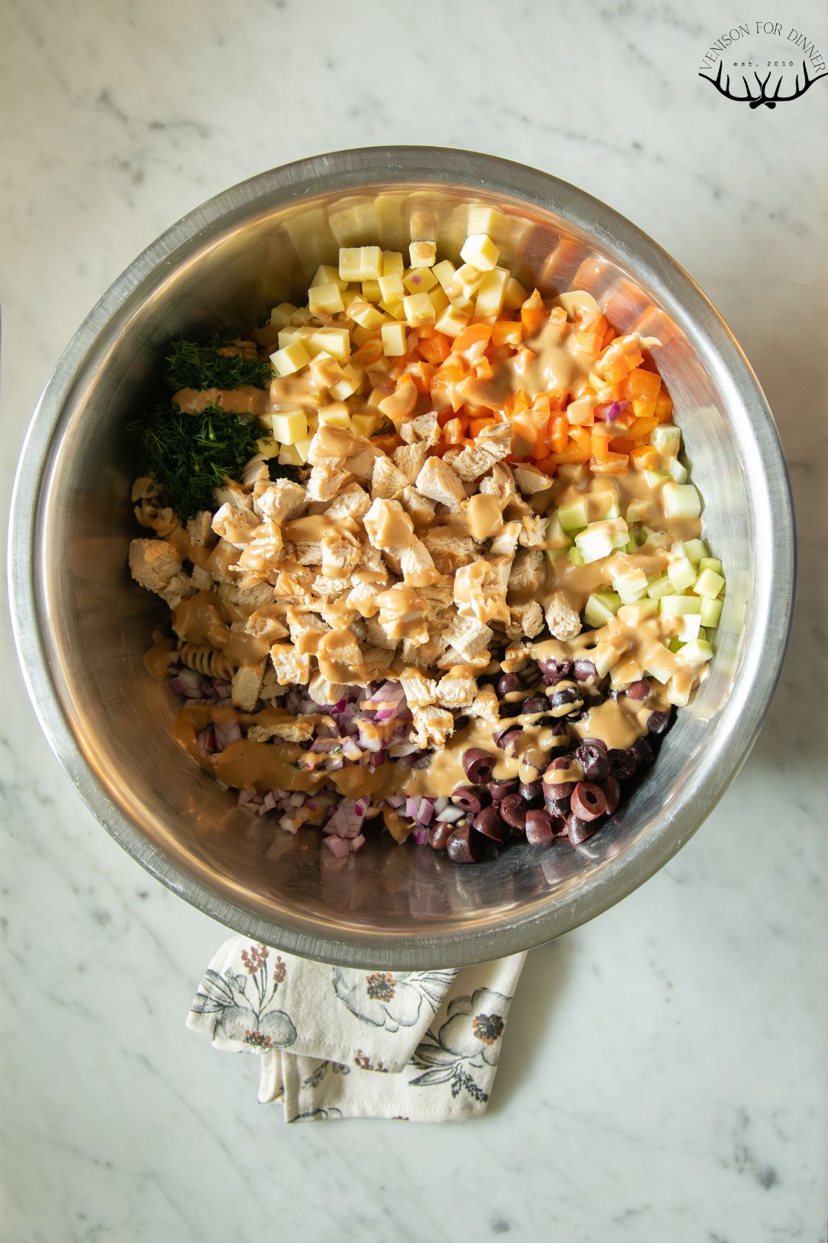 Chopped chicken salad ingredients in a mixing bowl.