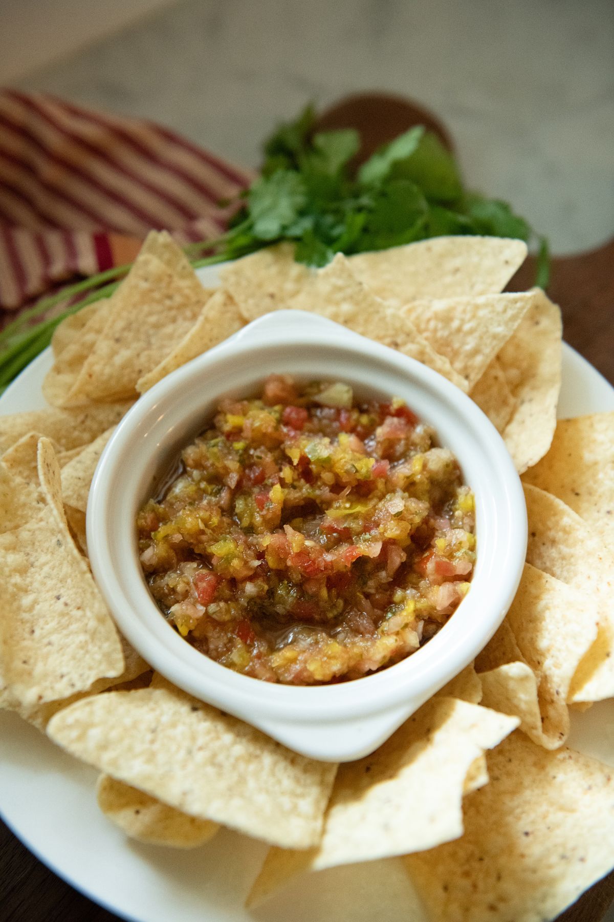 Bowl of tomato salsa with chips.