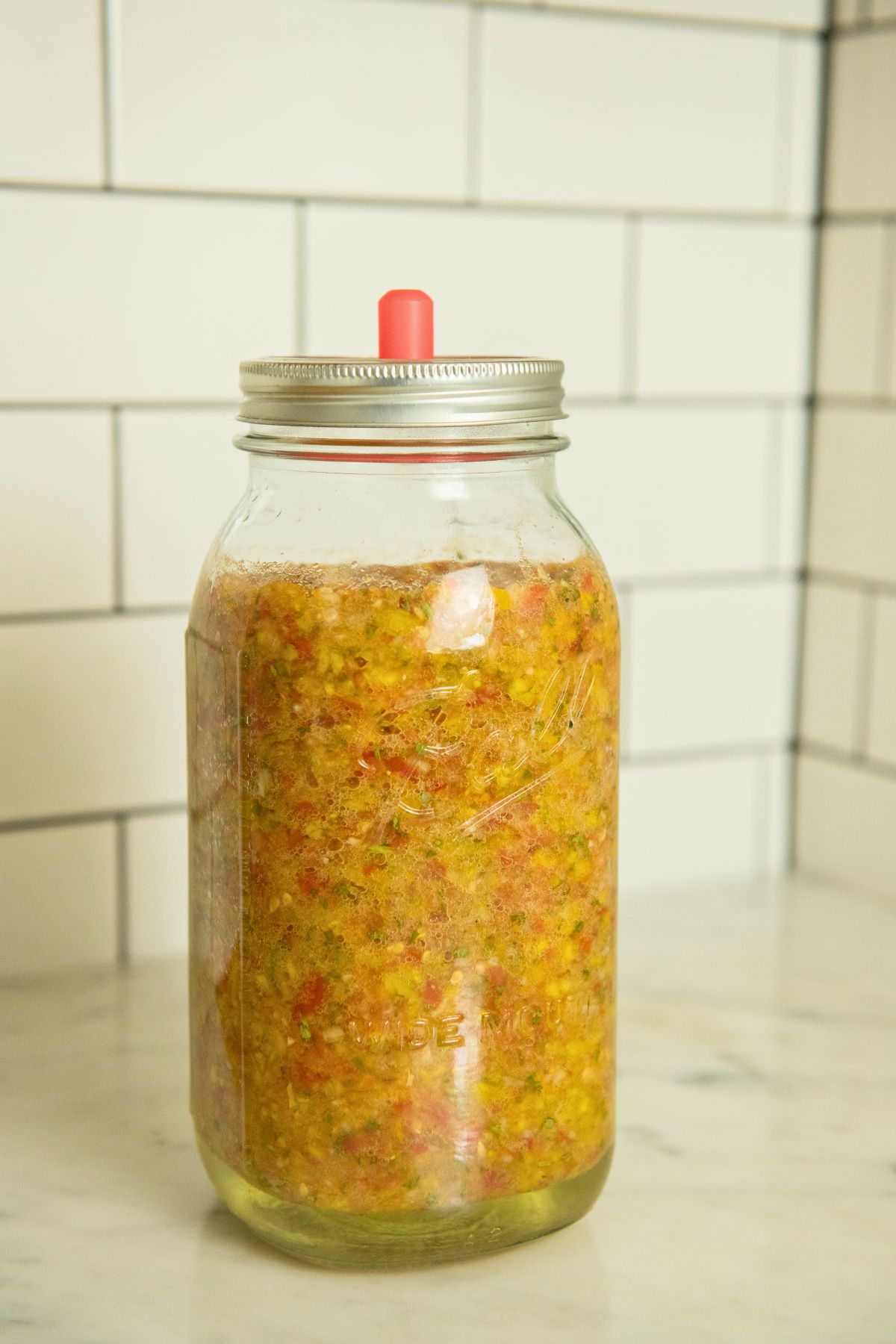 Salsa fermenting in a mason jar.