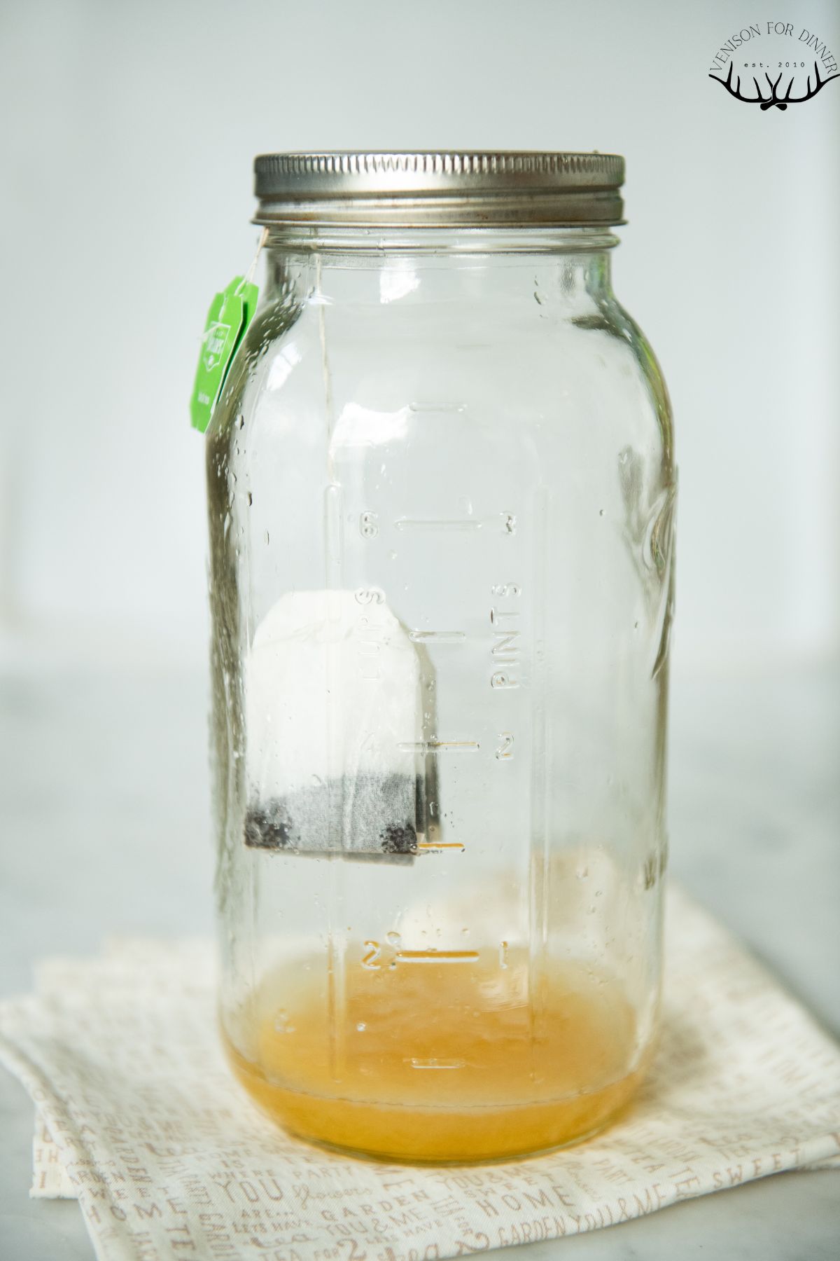 Tea bags and honey in a mason jar.
