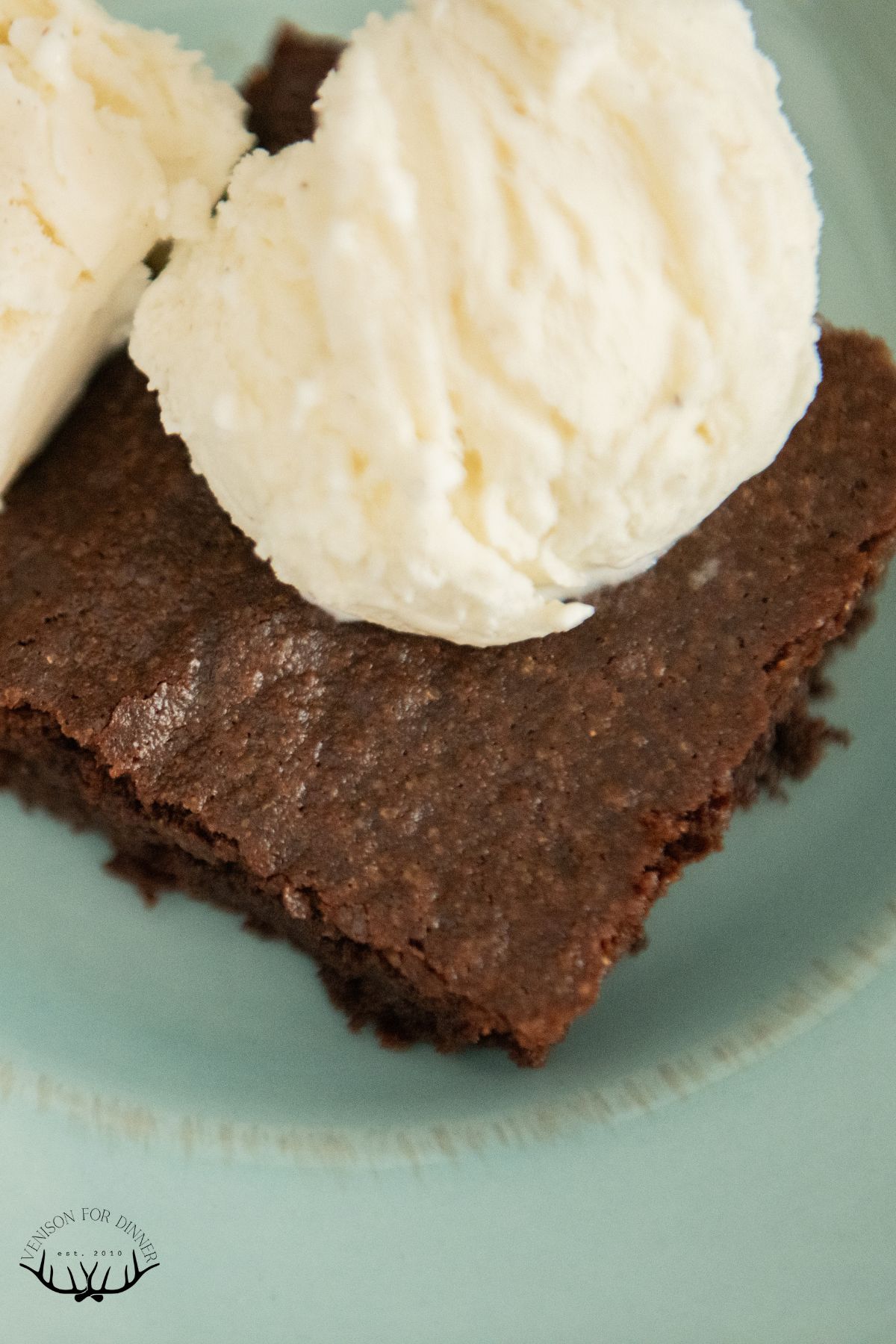 Brownie topped with vanilla ice cream.