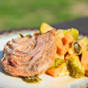 Pork chop with Brussels sprouts and sweet potatoes.