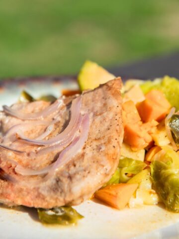 Pork chop with Brussels sprouts and sweet potatoes.