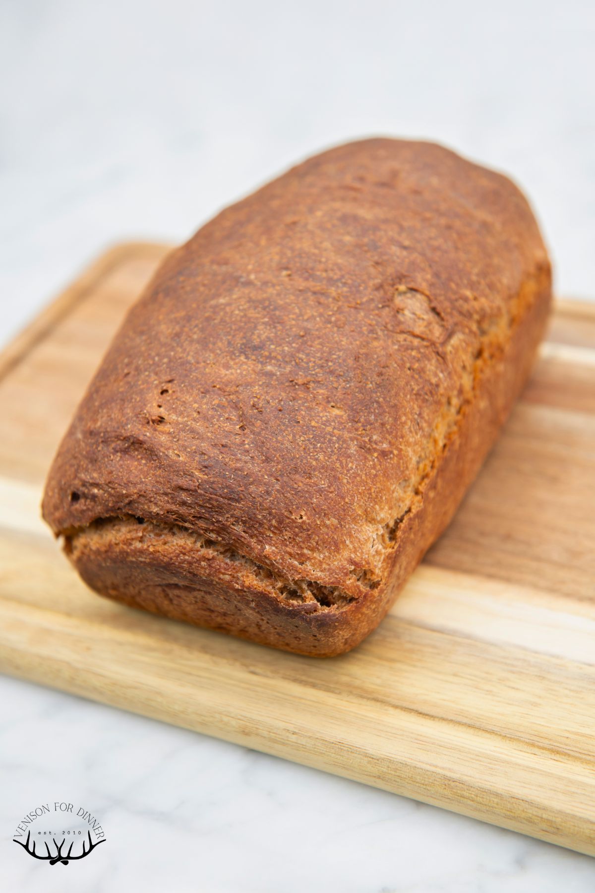 Baked loaf of sourdough brown bread.