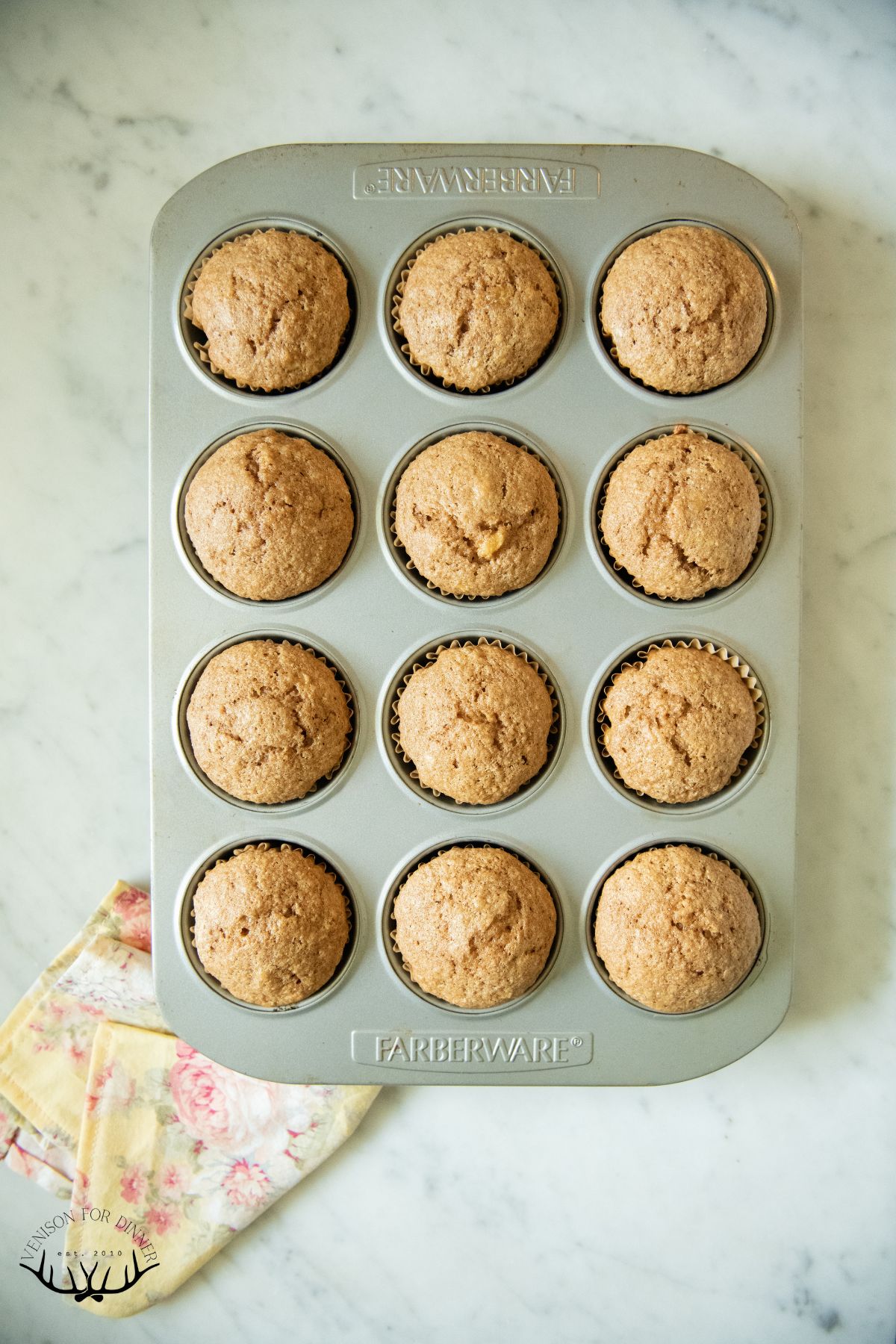 Baked banana spelt muffins in a tin.