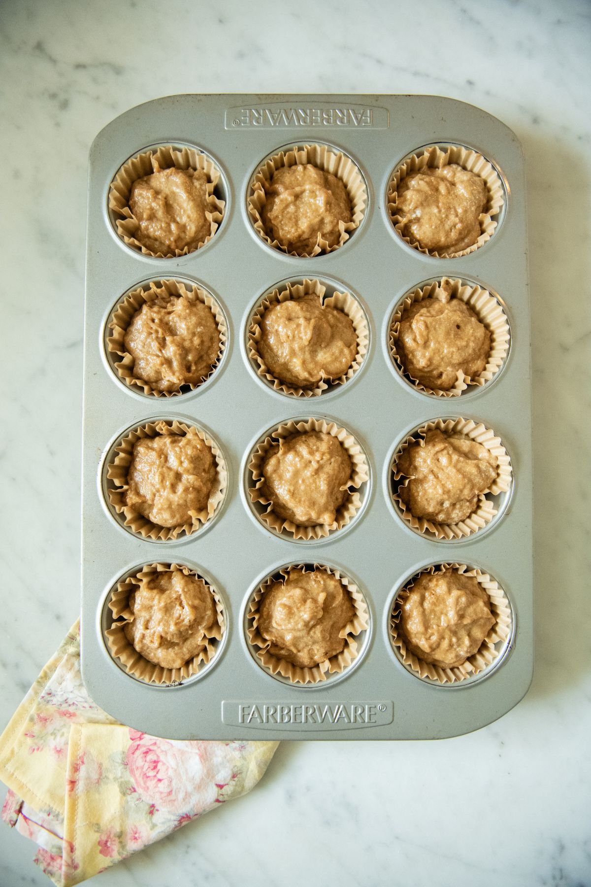 Lined muffin tin with banana spelt batter.