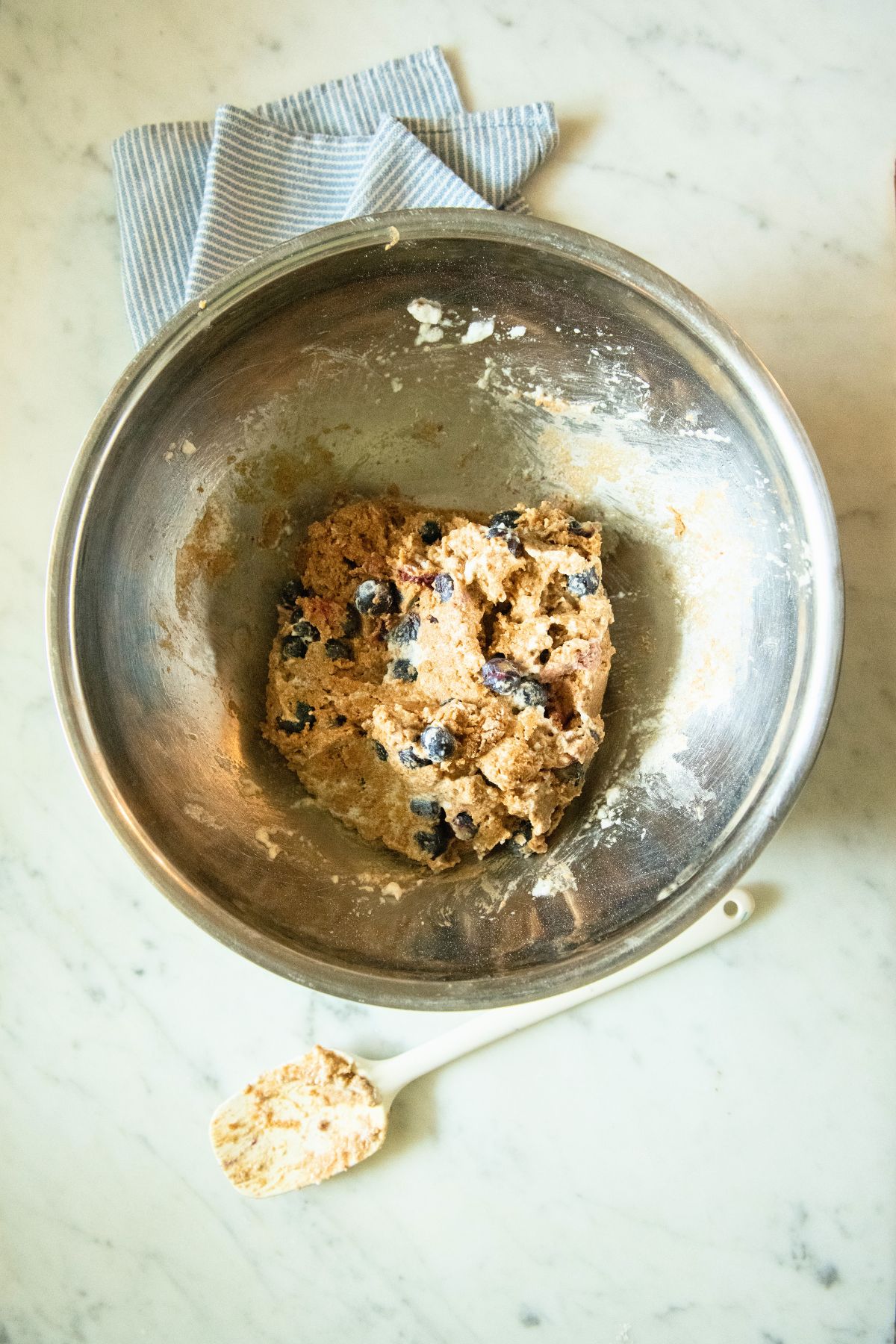 Blueberries folded into muffin batter.