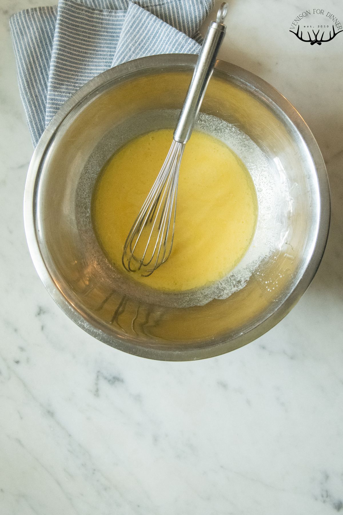 Whisked butter and eggs in a bowl.