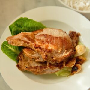 Brined bone-in pork chops served with garlic.