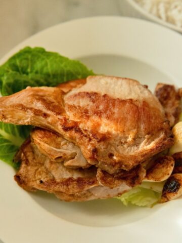 Brined bone-in pork chops served with garlic.
