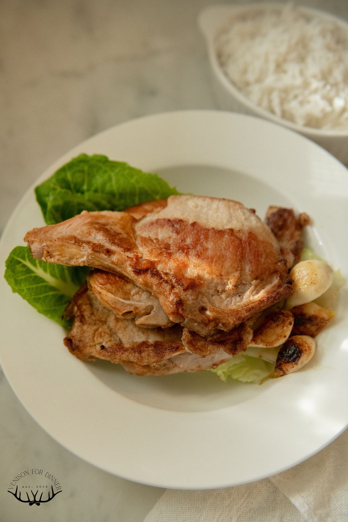 Bone-in brined pork chops with garlic.