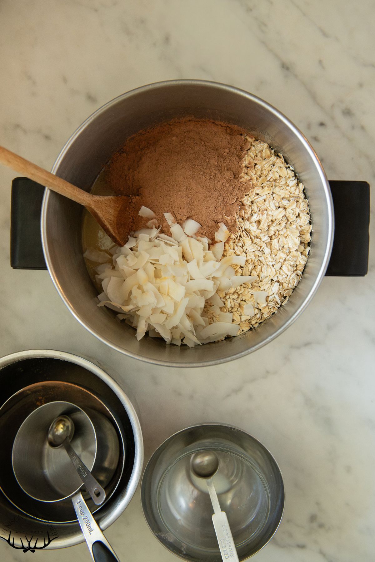 Stirring oats and coconut into butter.