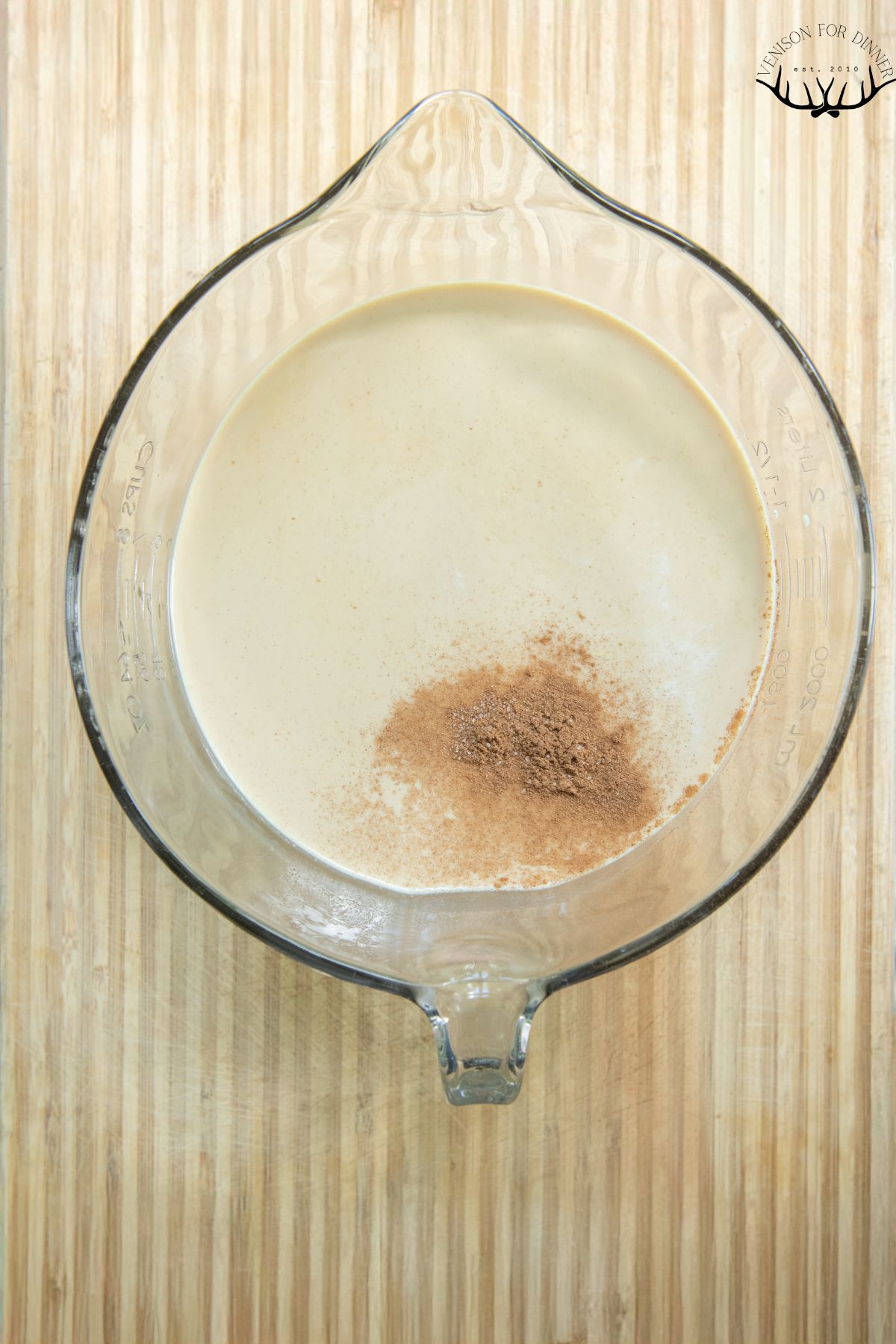 Stirring cinnamon into coffee cream.