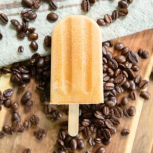 Coffee ice pop over coffee beans.