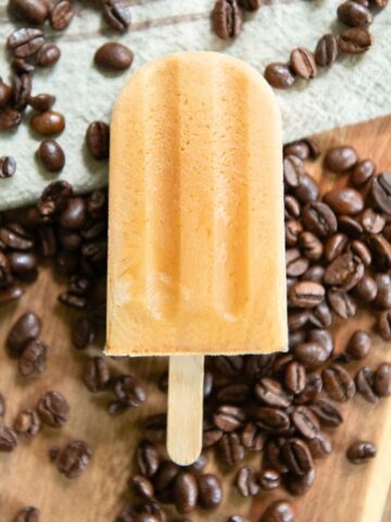 Coffee ice pop over coffee beans.