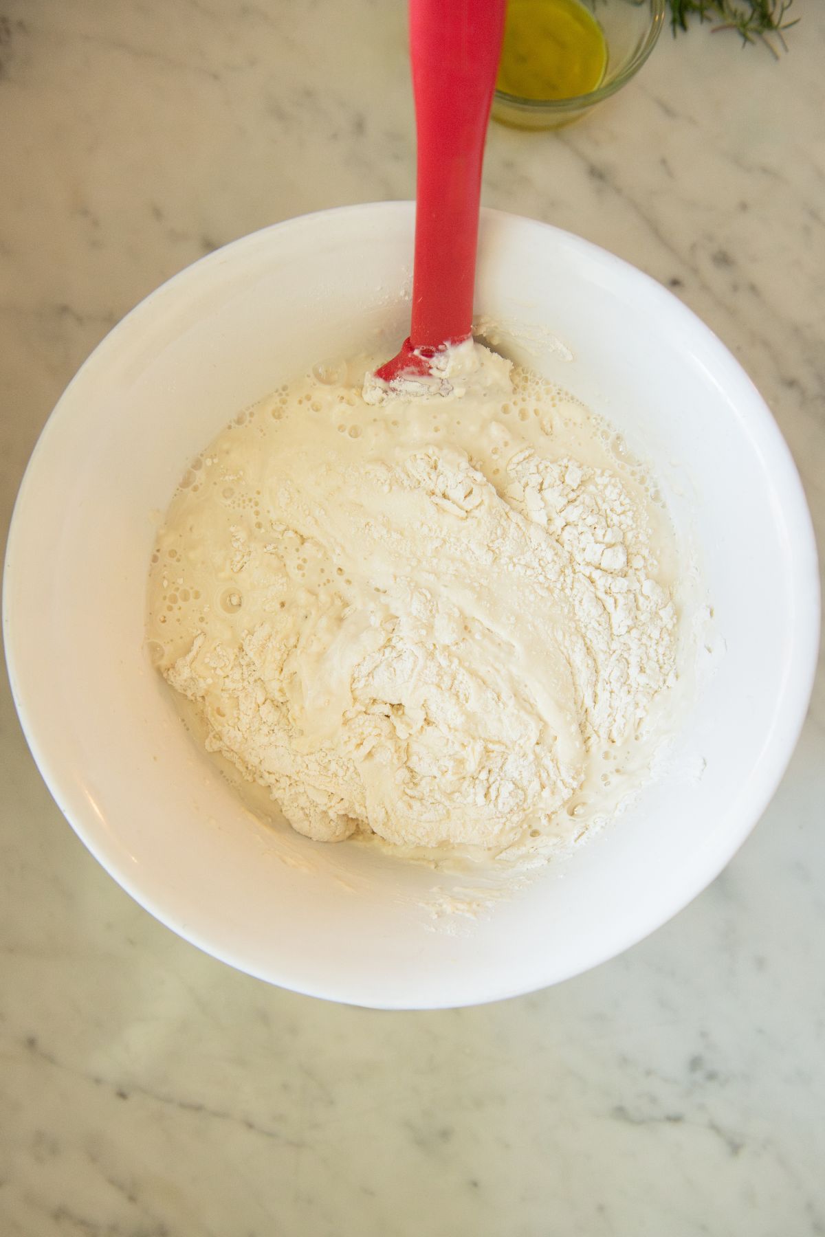 Mixing focaccia dough in a bowl.