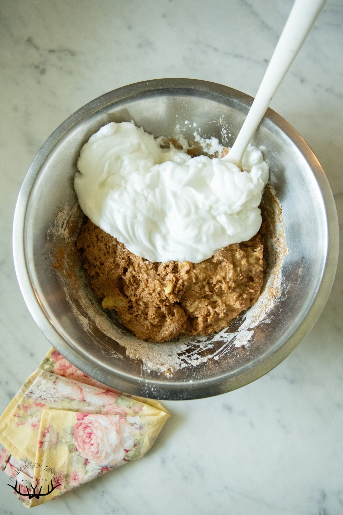 Folding egg whites into banana muffin batter.