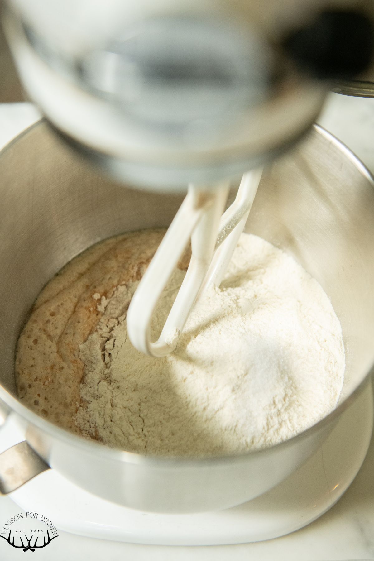Adding flour to bloomed yeast.