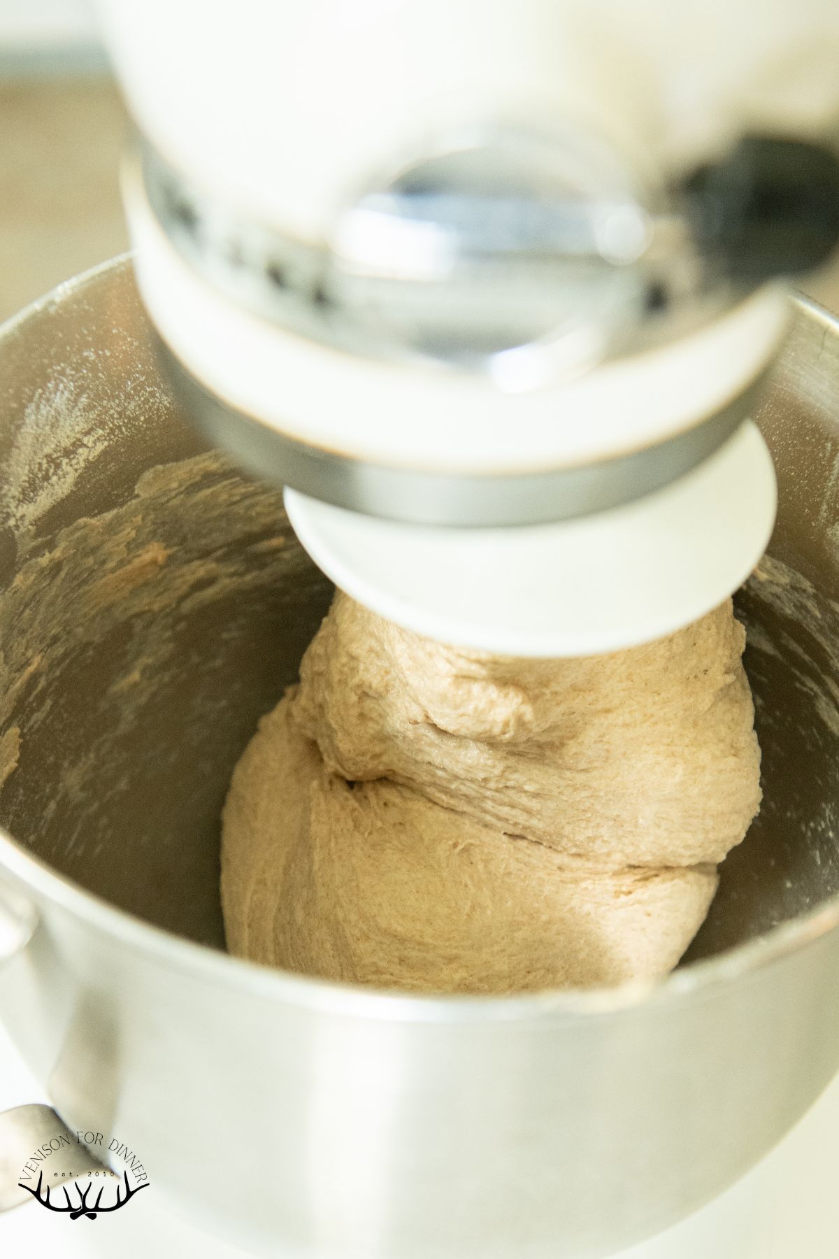 Mixing pizza dough in a stand mixer.