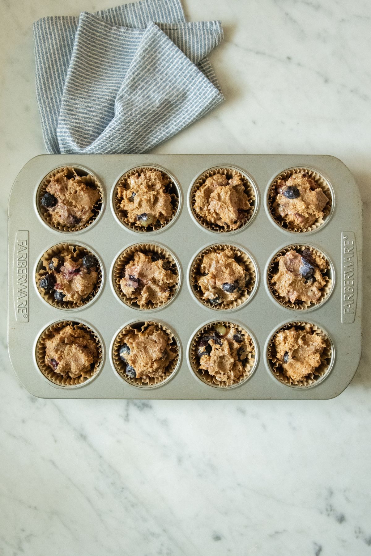 Blueberry muffin batter in a tin.