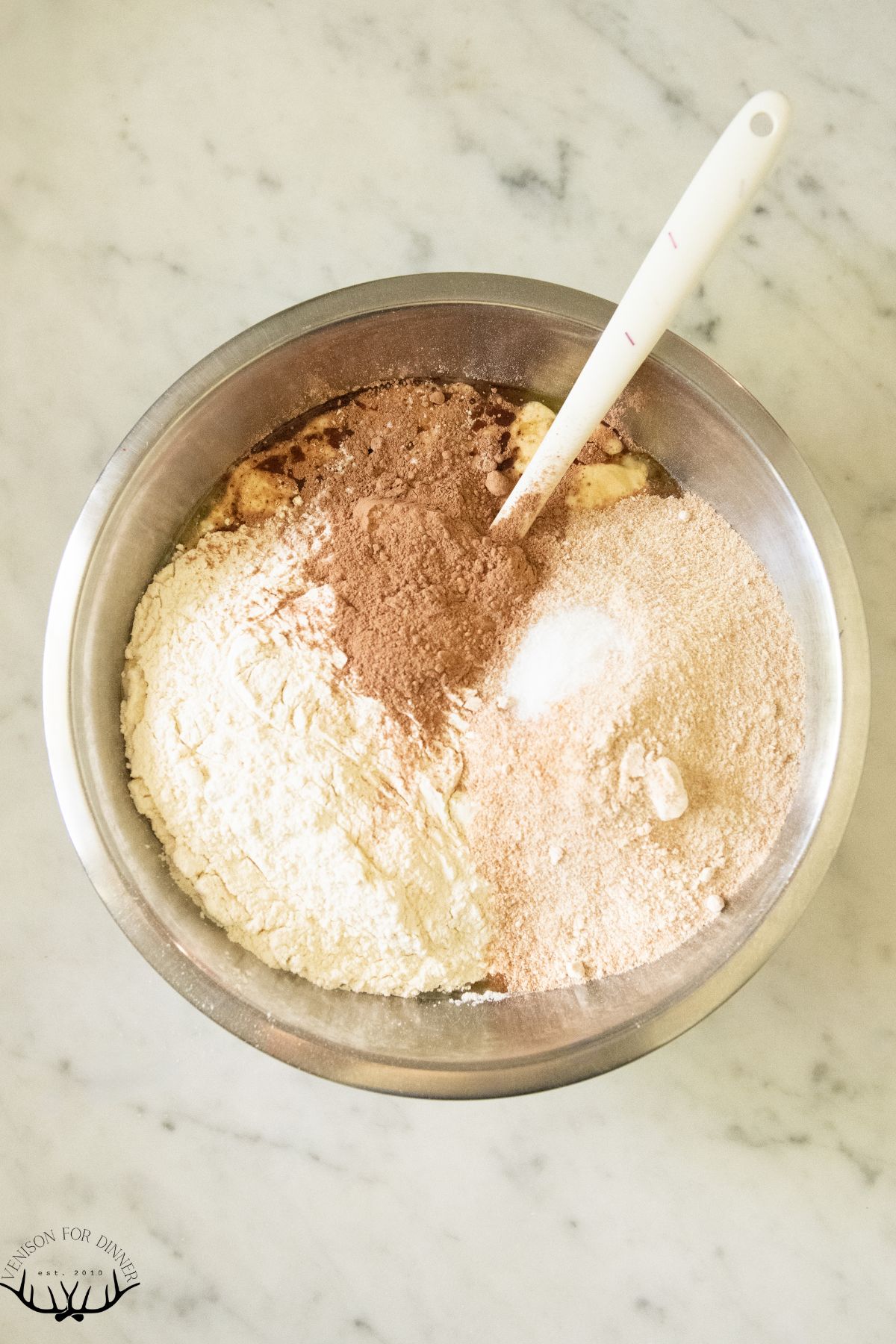 Stirring flour into bread dough.
