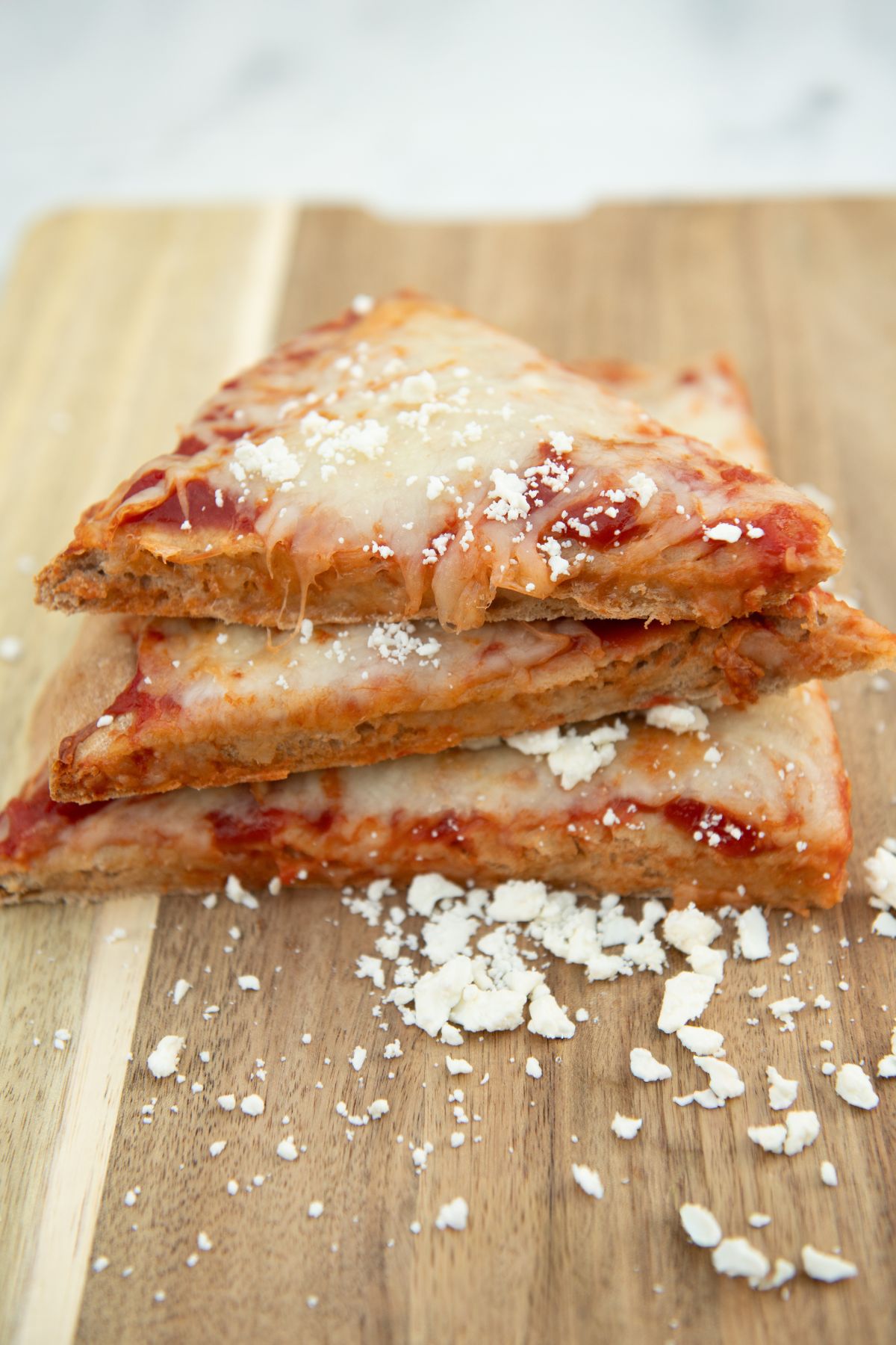 Slices of cheese pizza on whole wheat dough.