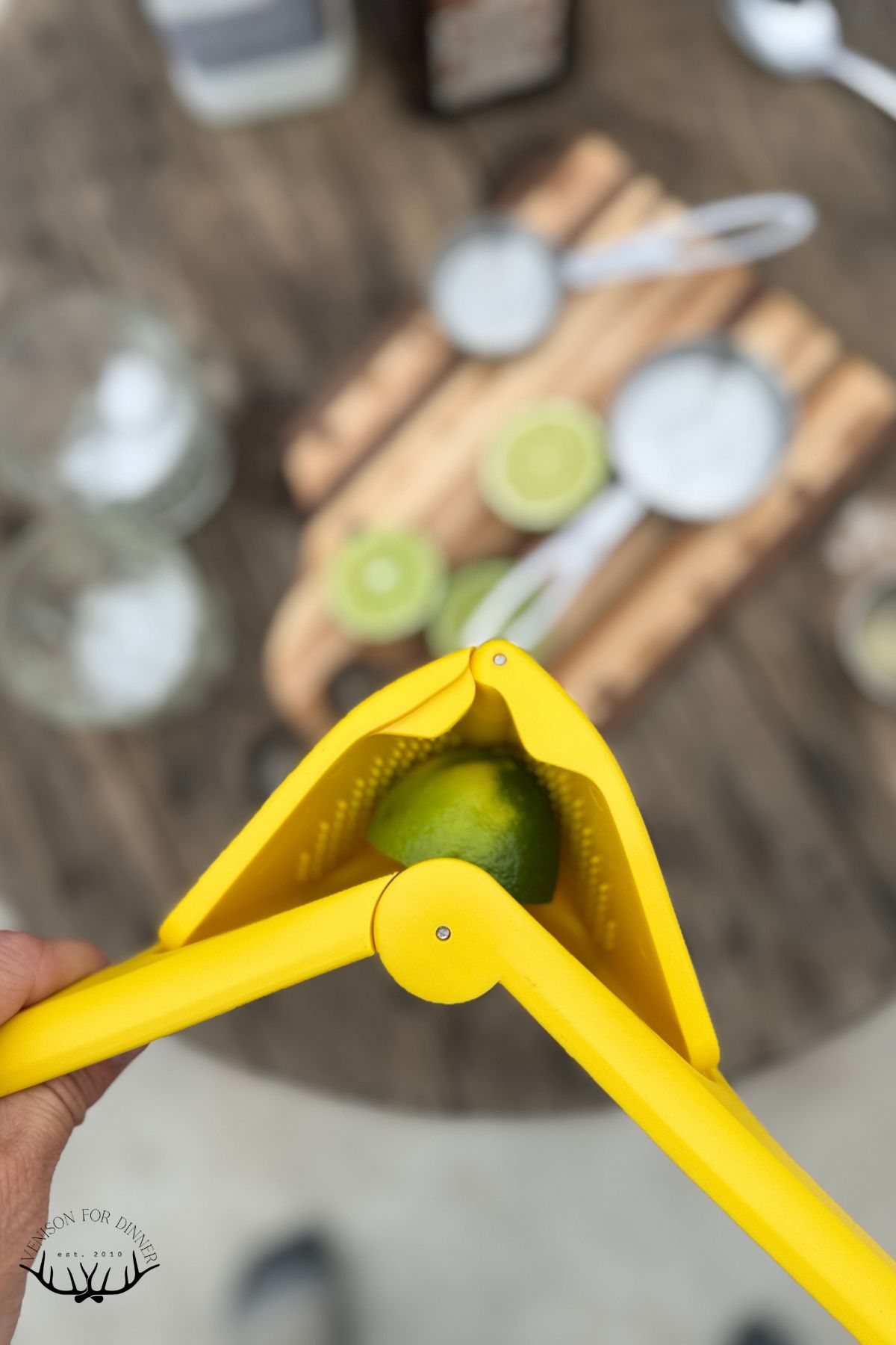 Squeezing limes over a jar.