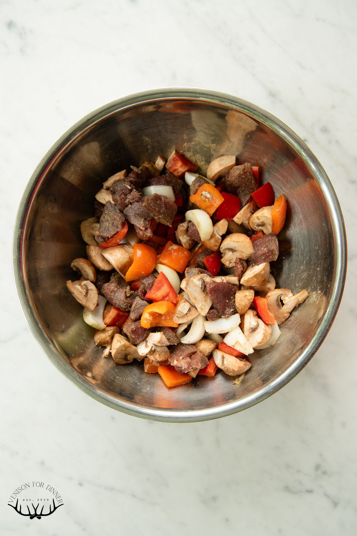 Bowl of marinating kabob ingredients.