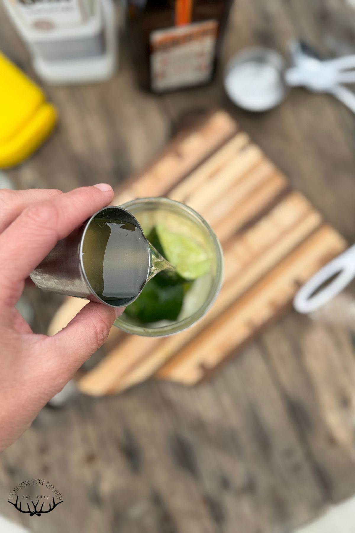 Pouring liquor over lime juice.
