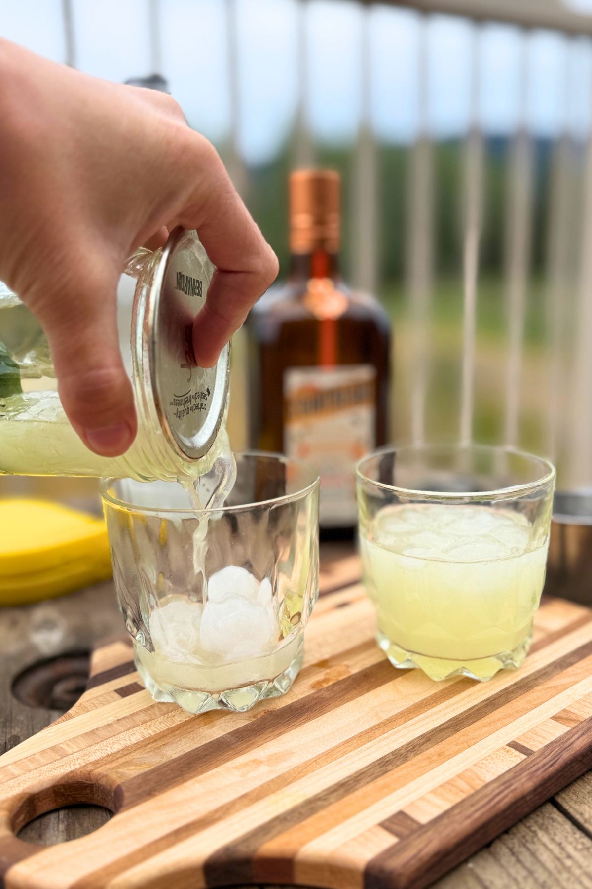 Straining a margarita into a glass.