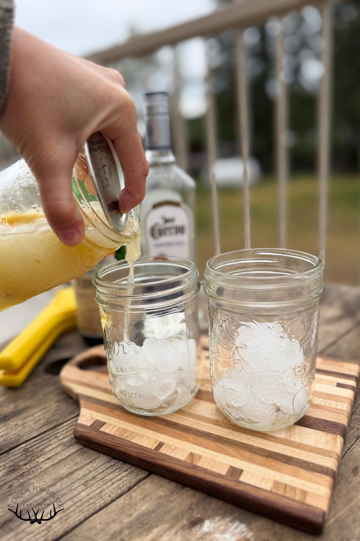 Stringing tequila drink into drinking jars.