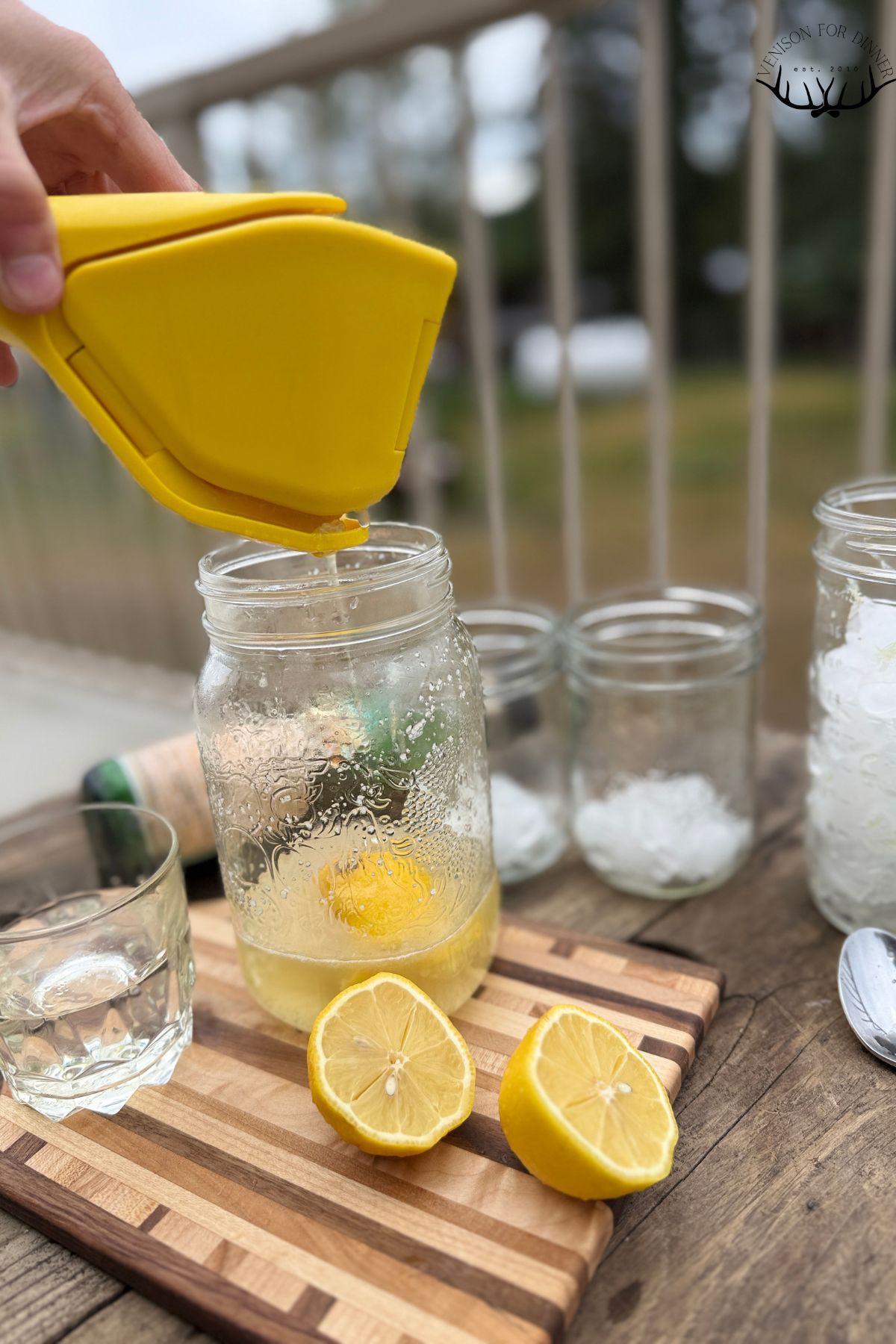 Juicing lemons into a jar.