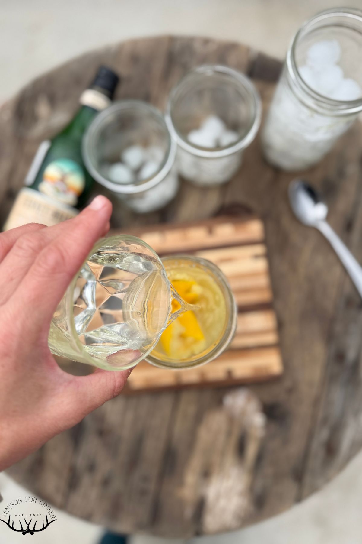 Pouring tequila over lemon.