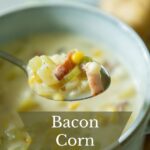 A spoon of bacon corn chowder with potatoes.