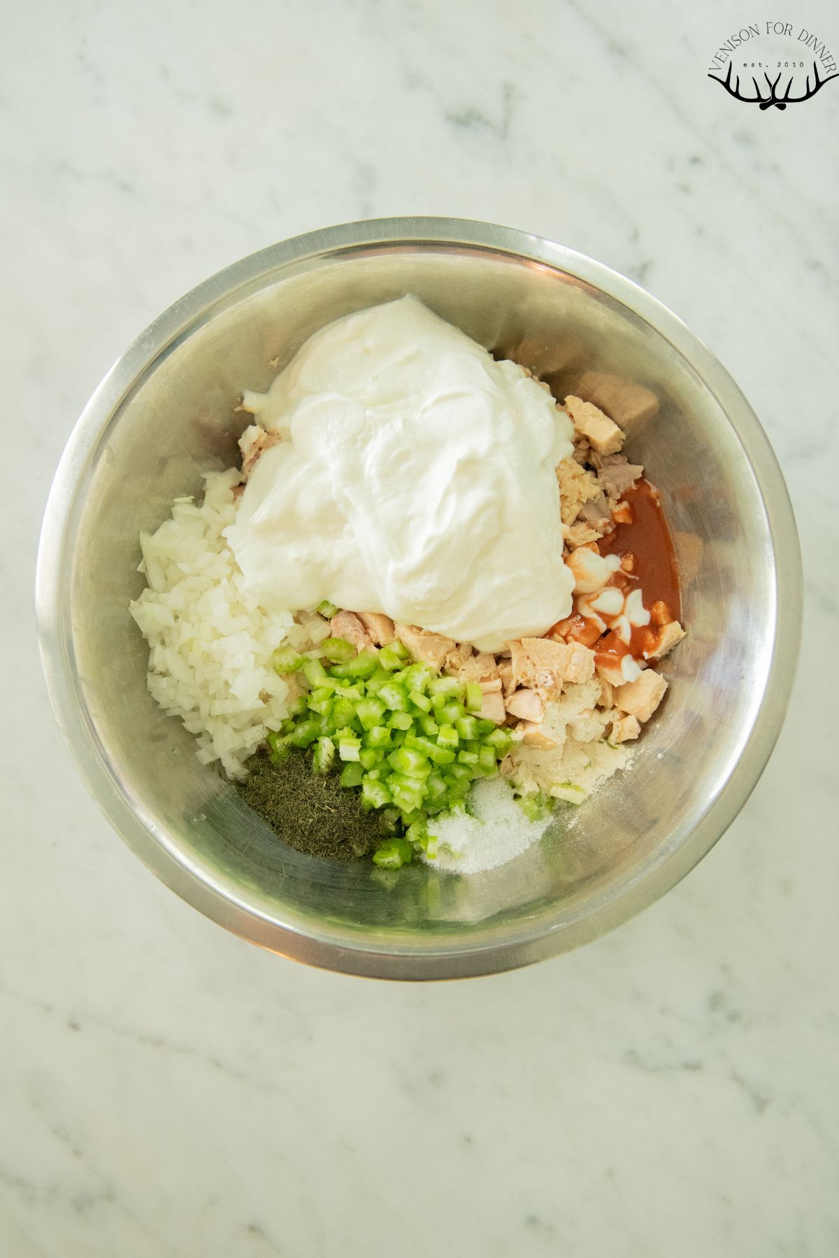 Buffalo chicken salad in a bowl to mix.