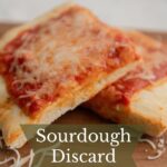 Slices of sourdough discard pizza dough.