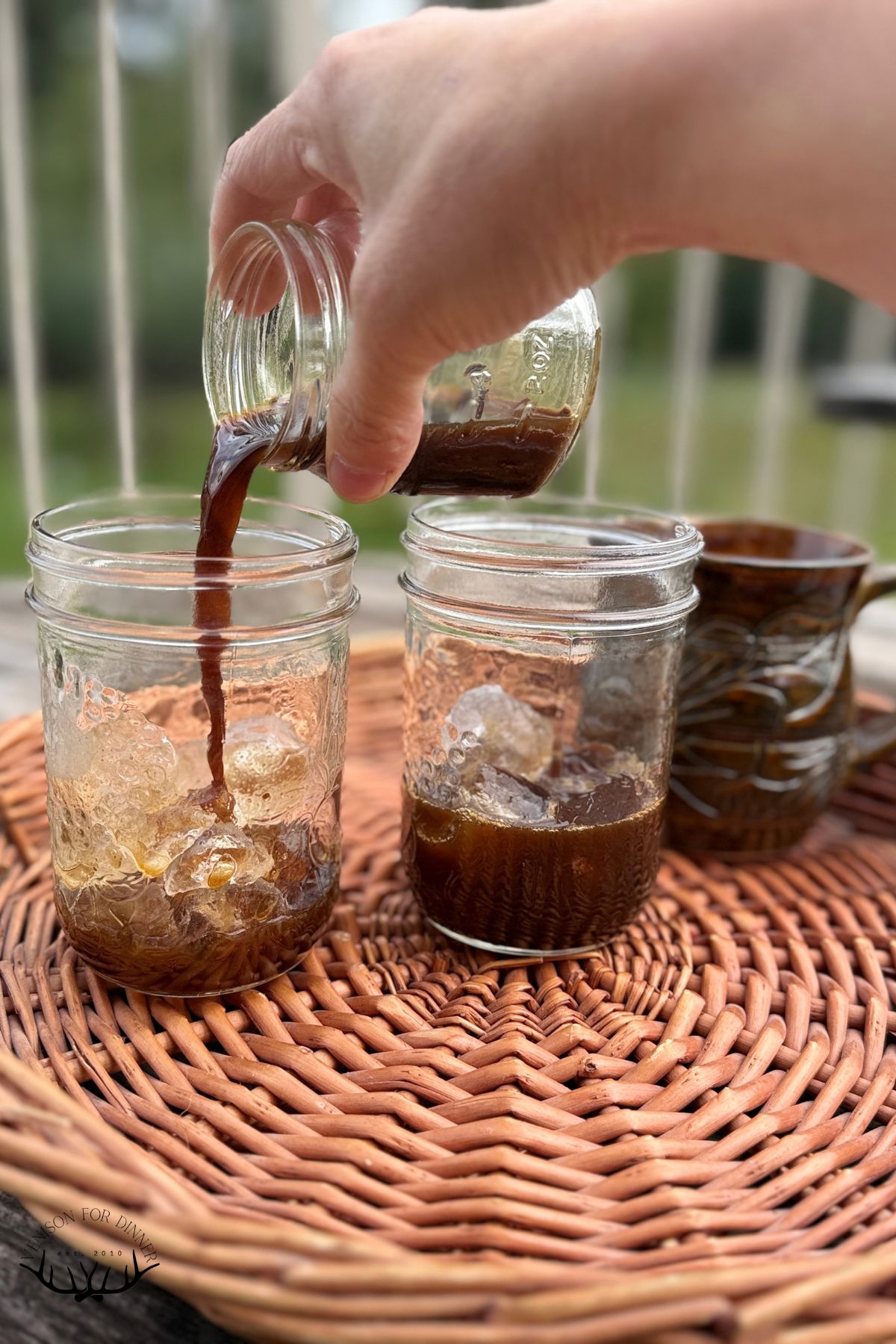 Pouring brewed espresso shots over ice.