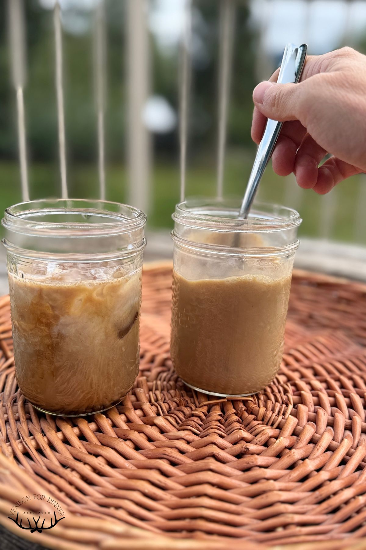 Stirring pumpkin syrup into a latte.