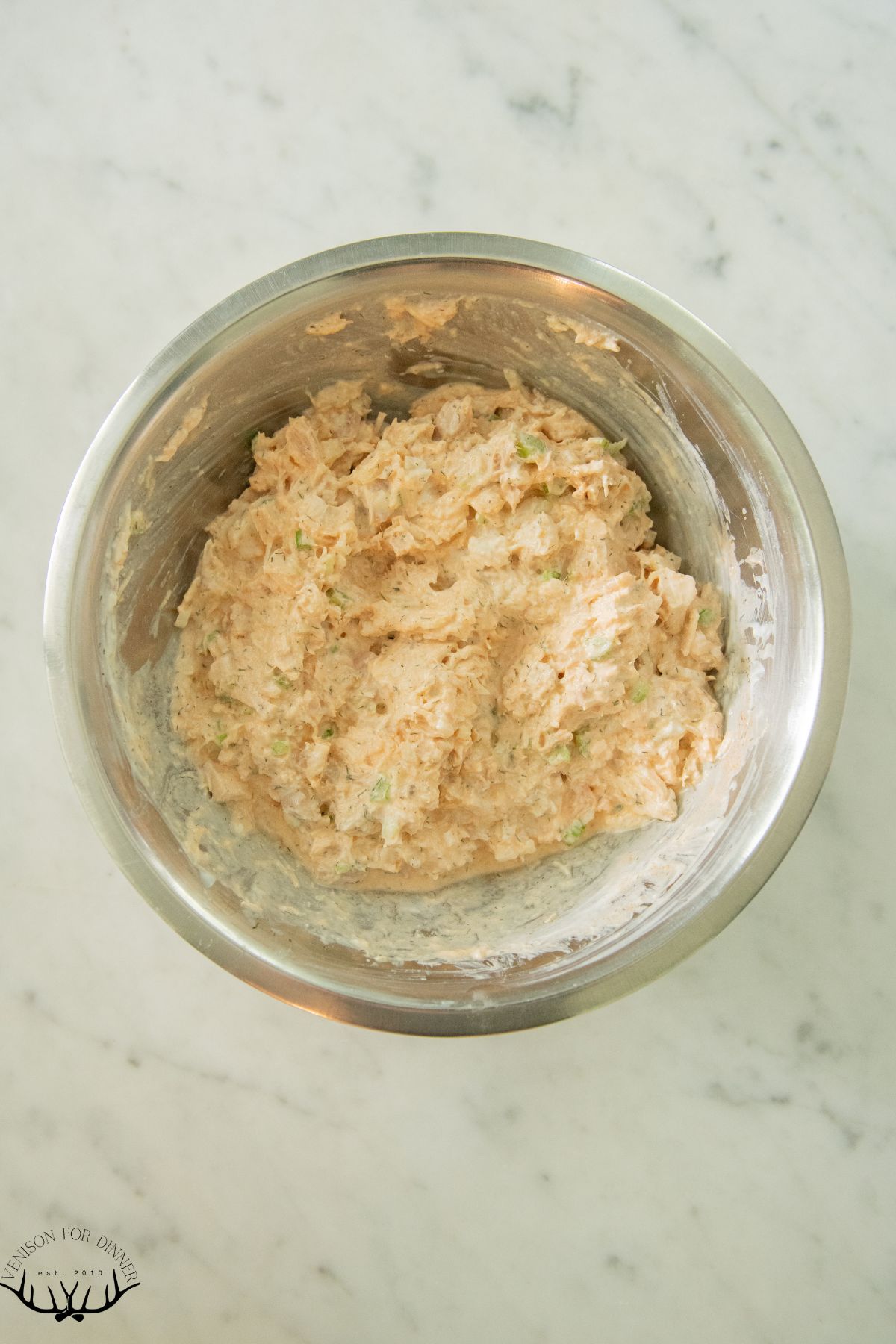 Mixed buffalo chicken salad in a bowl.