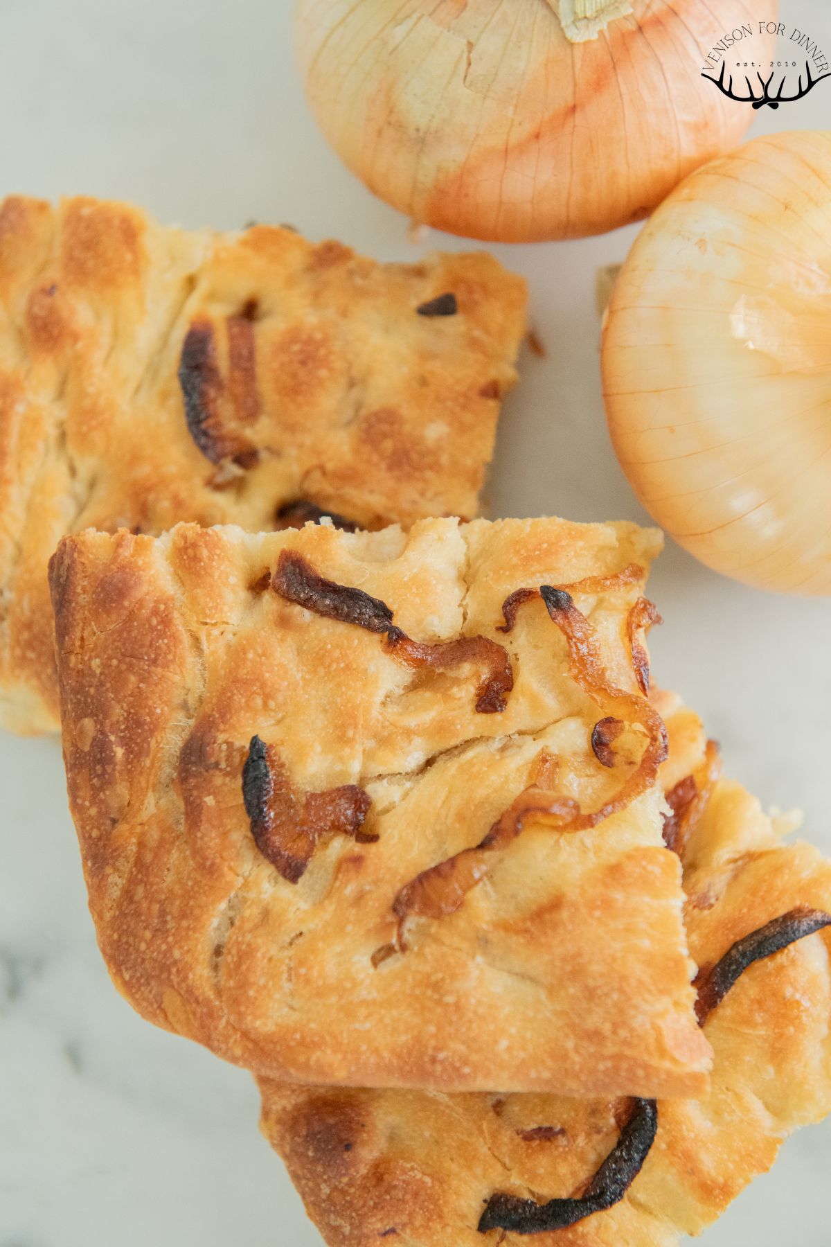 Slices cut from onion focaccia bread.