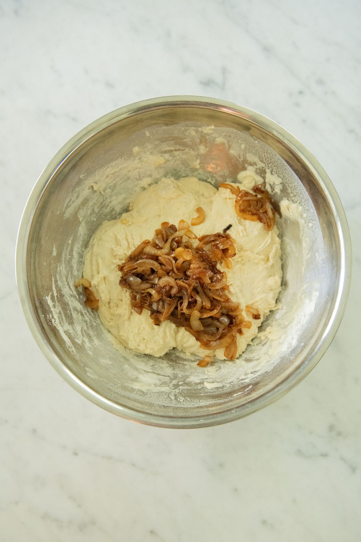 Caramelized onions on bread dough.