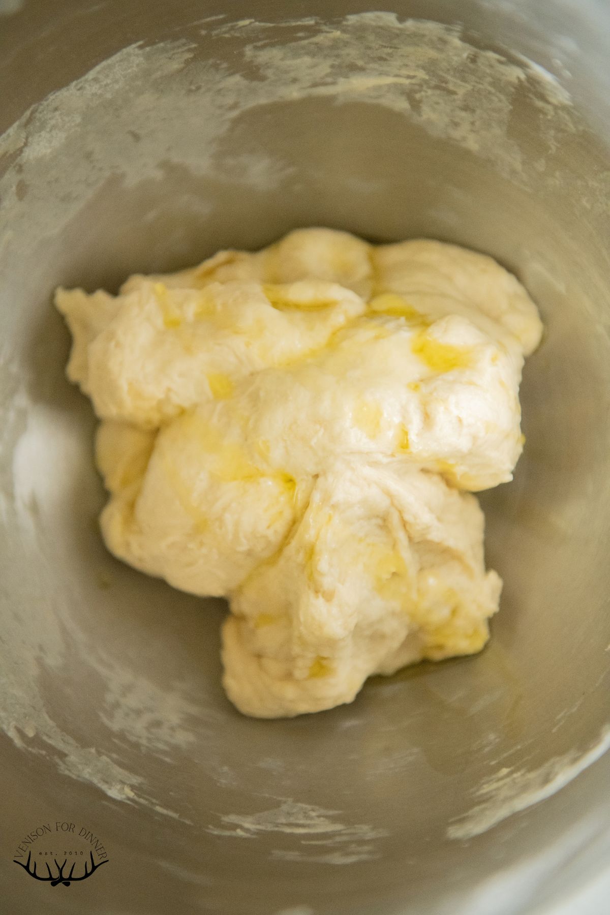 Oil drizzled over pizza dough ball.
