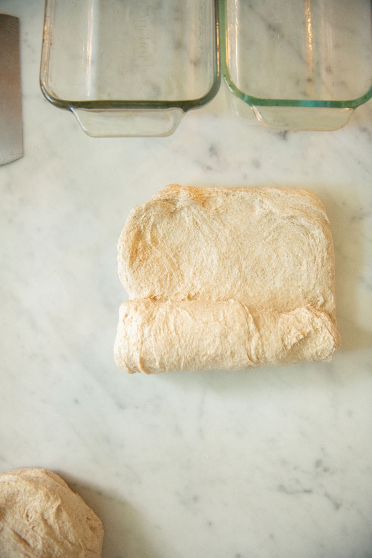 Rolling up bread dough into a loaf.